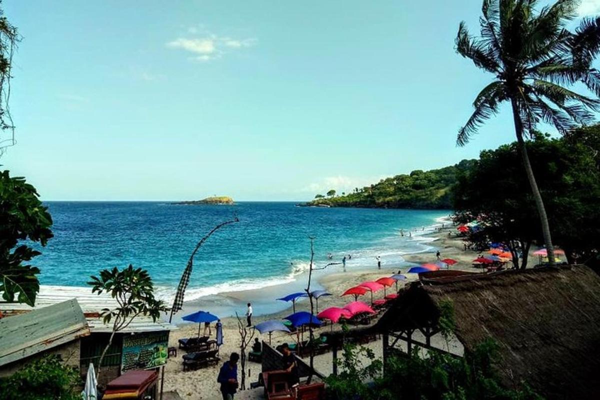 a beach with umbrellas and people on the beach