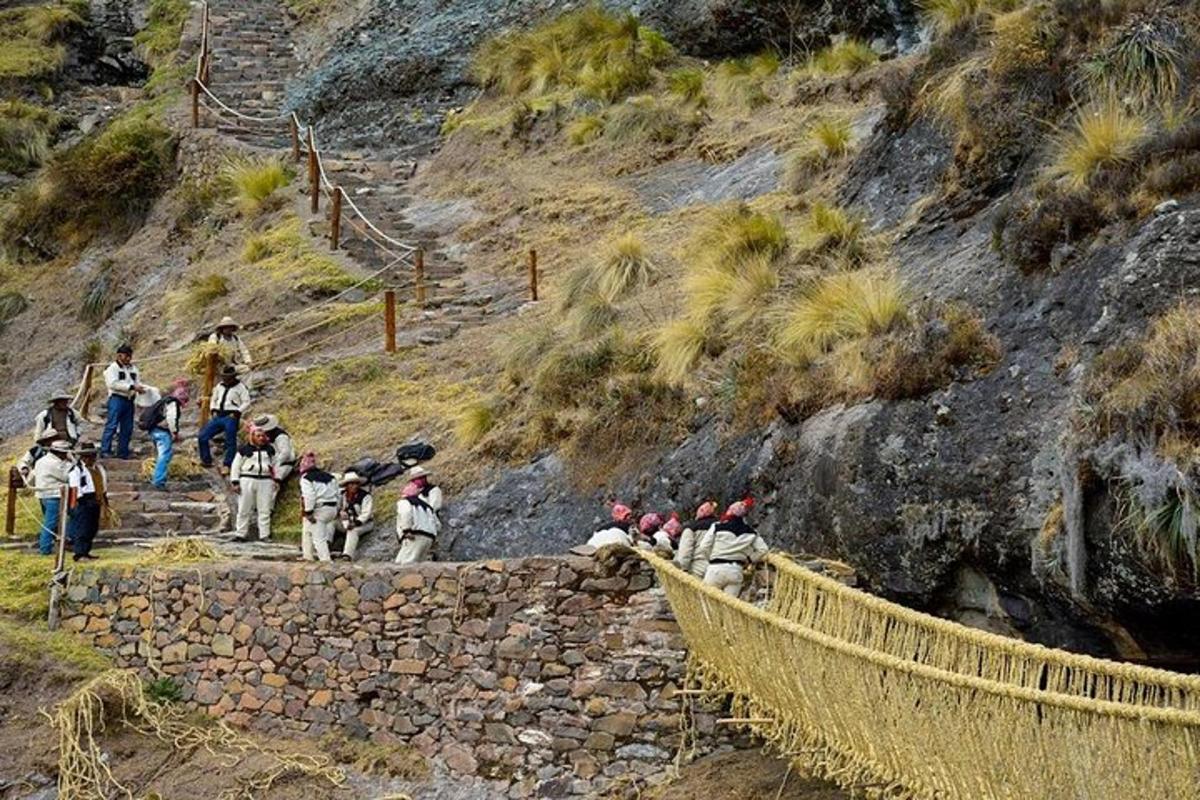 a group of people walking up a rocky mountain