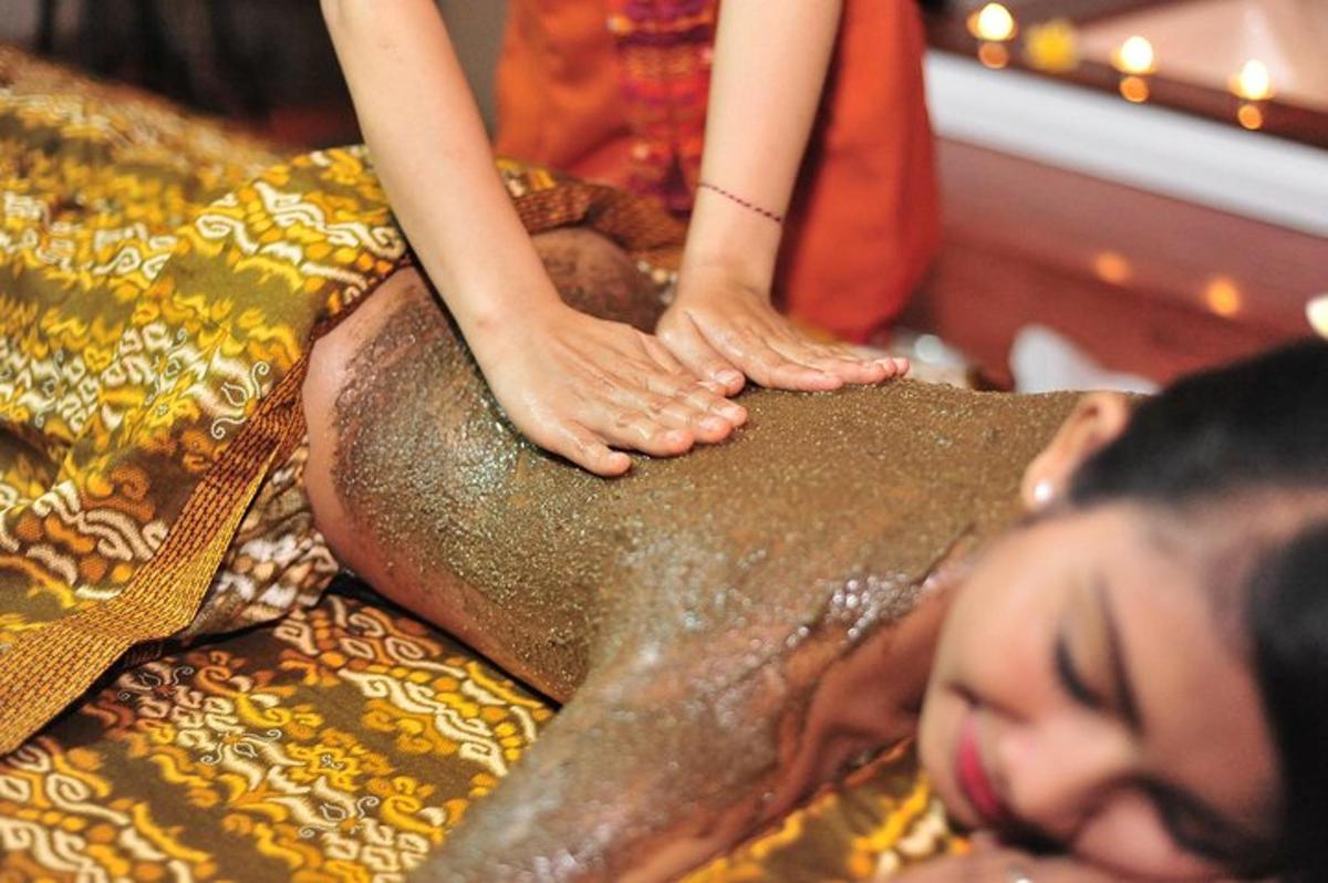 a woman is getting a massage on a mans back