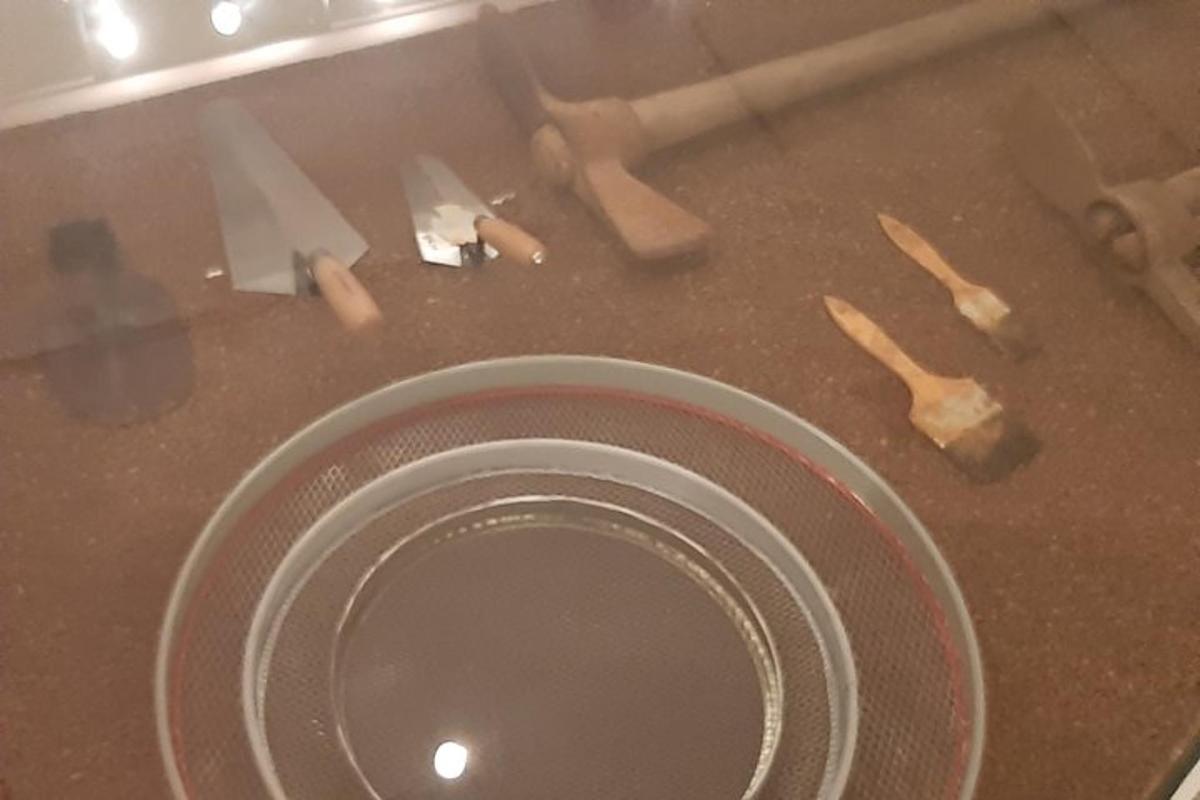 a close up of a sink with knives on it