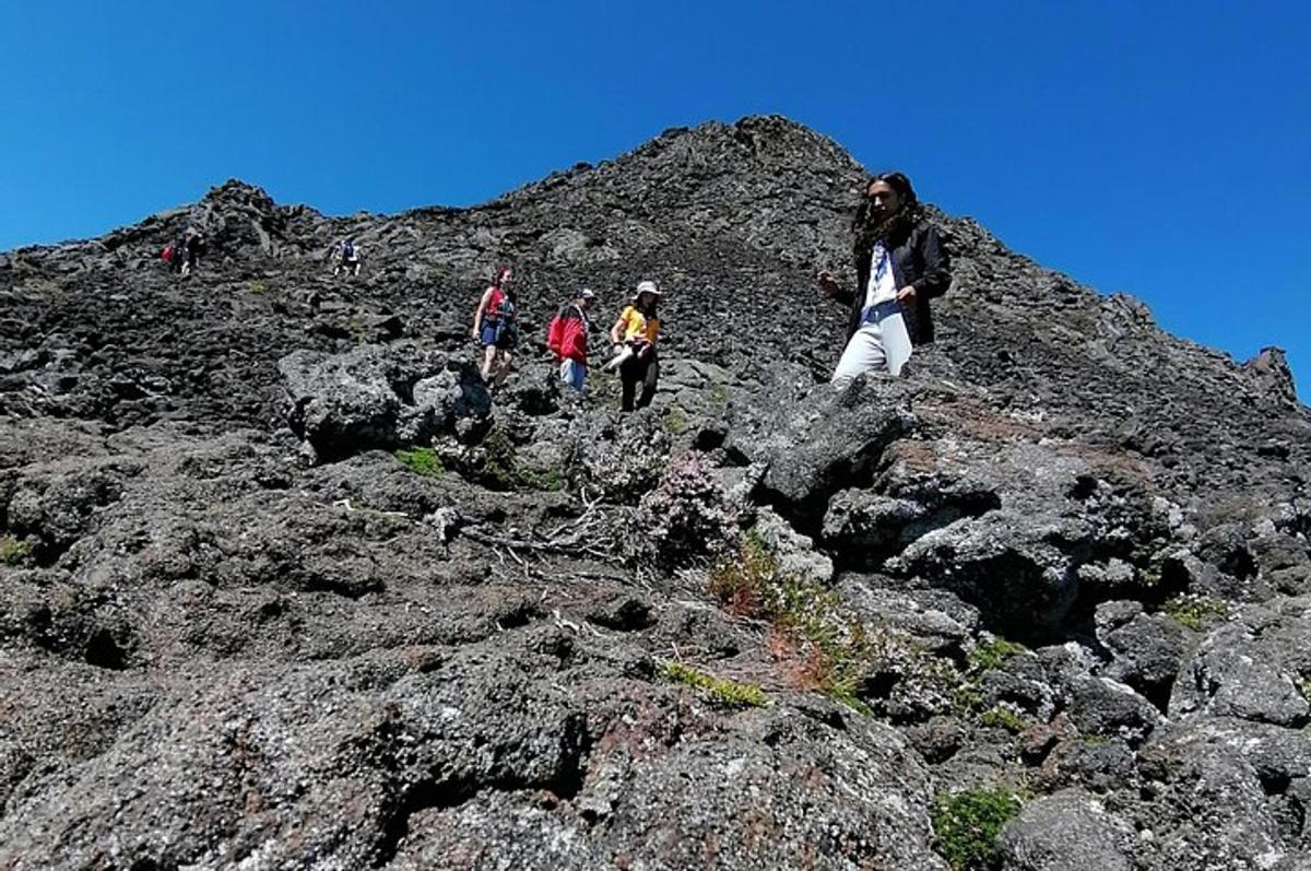 a group of people walking on a rocky mountain