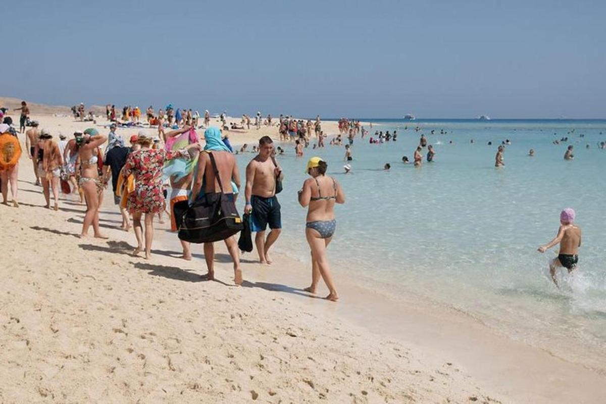 un grupo de personas caminando por una playa