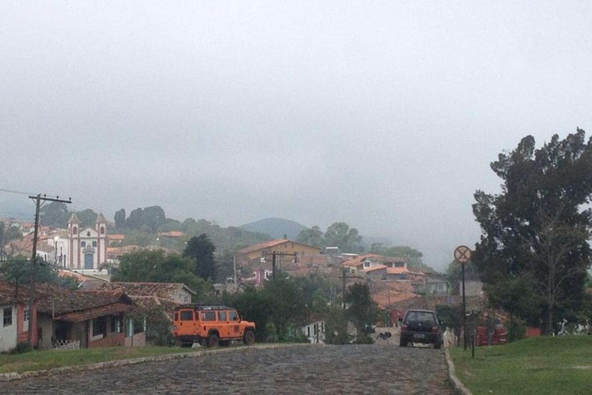 an orange truck parked in front of a town