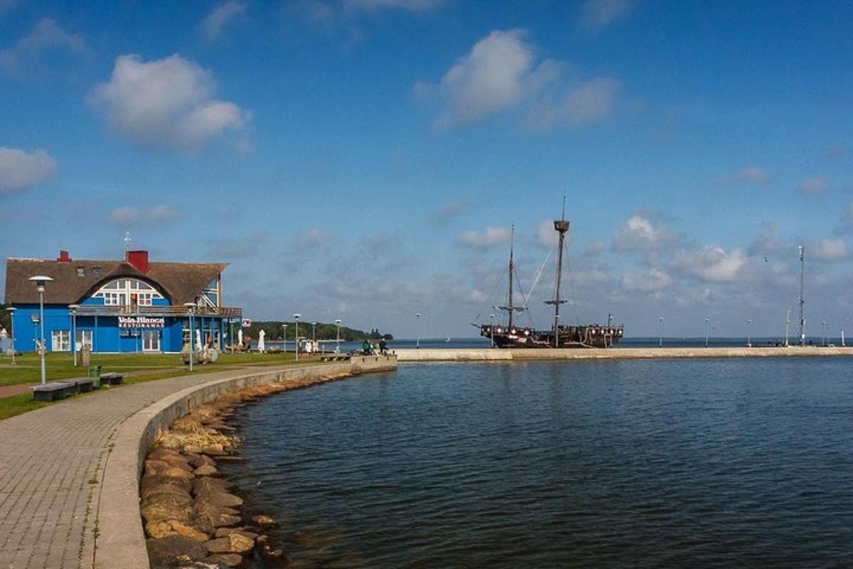 a body of water with a blue building and a house