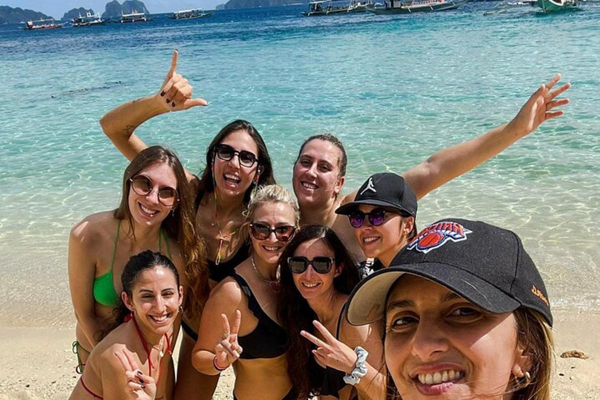 a group of people posing for a picture at the beach