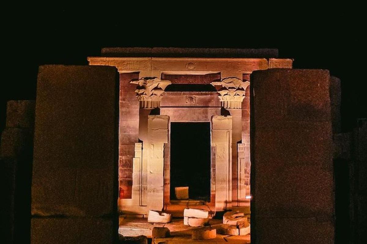 a large stone building with a doorway at night