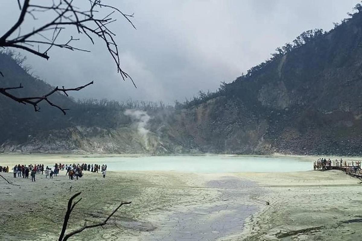 sekumpulan orang berjalan di pantai berhampiran tasik