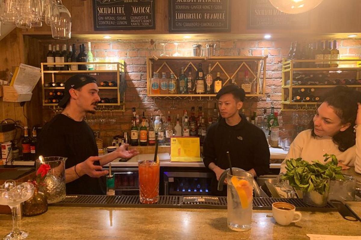 a group of men standing at a bar preparing drinks