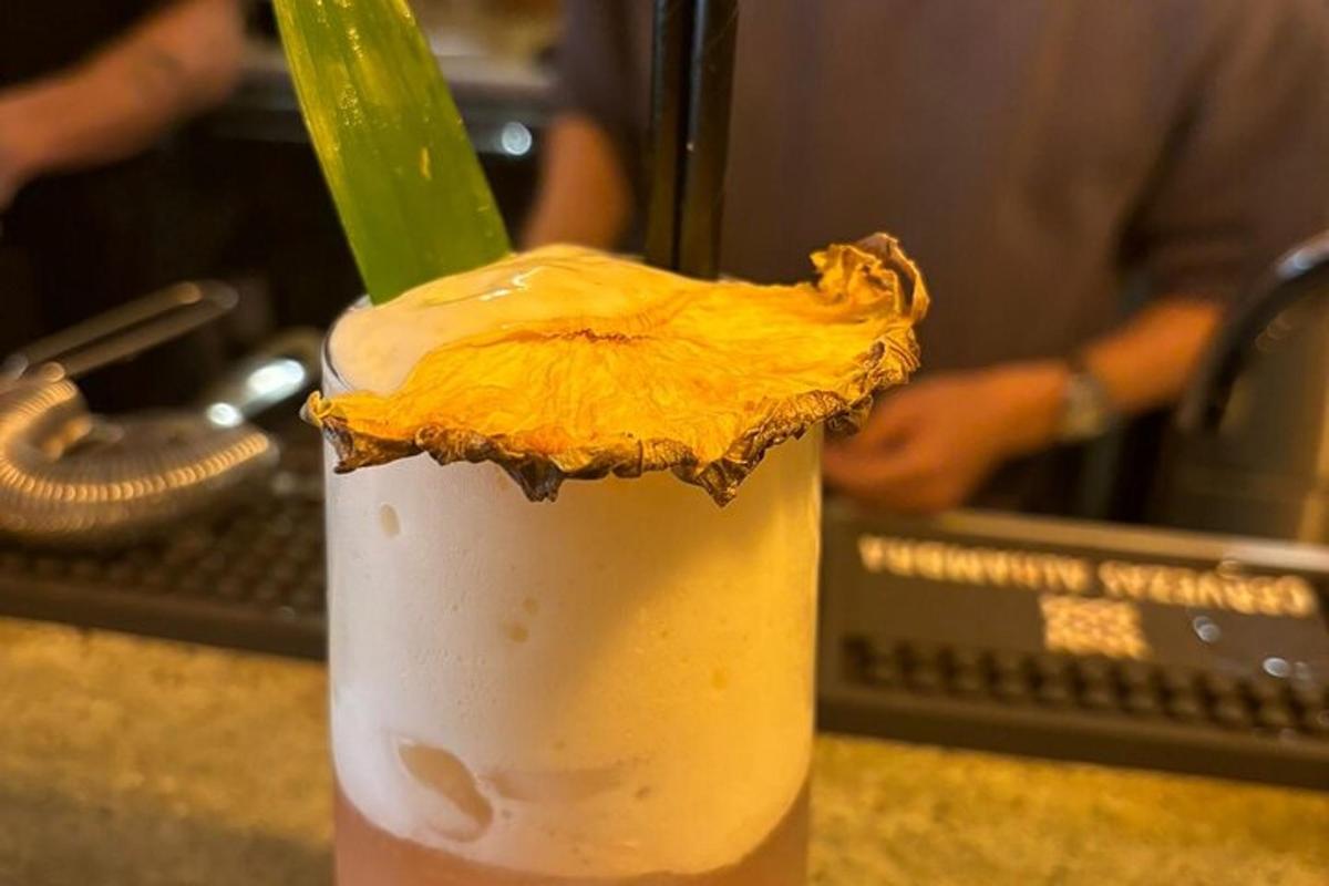 a drink with a green straw in a glass