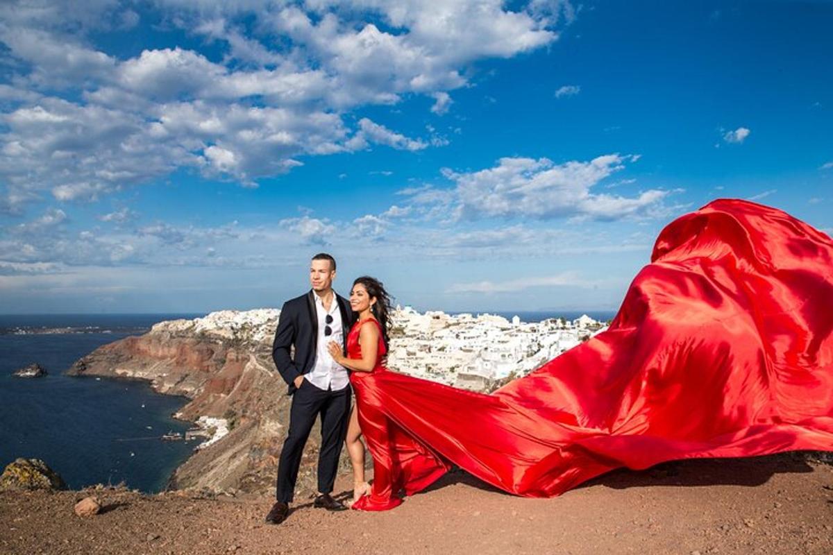 a man and a woman standing on top of a mountain with a red dress