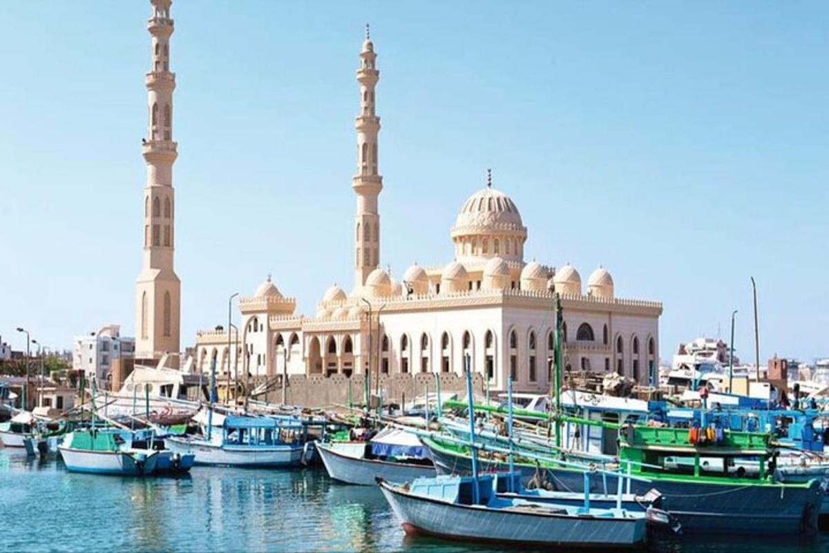 a group of boats in the water in front of a building