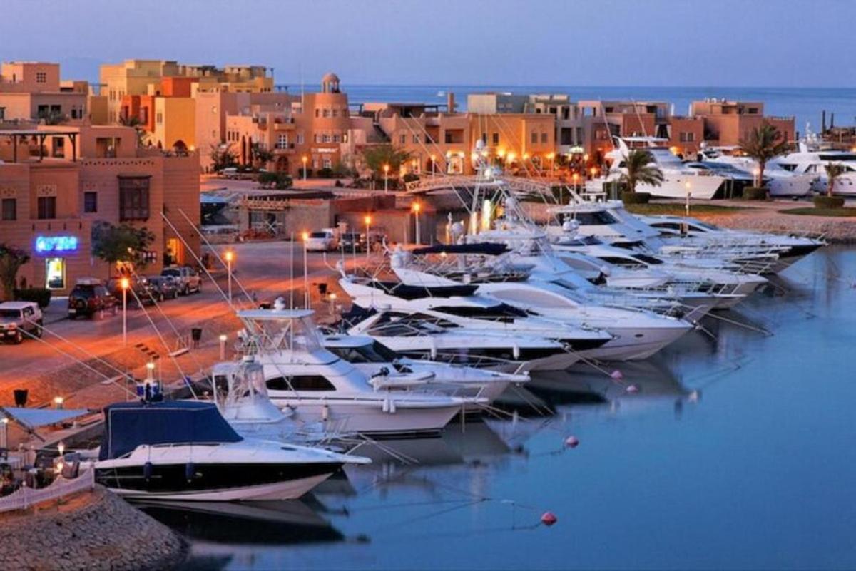 a group of boats parked in a marina at night