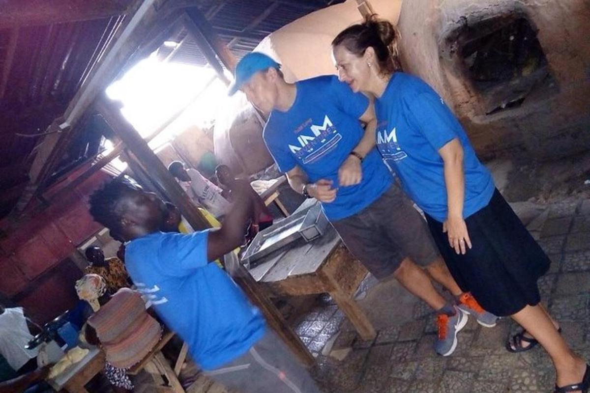 tre persone in camicia blu in piedi in una cucina