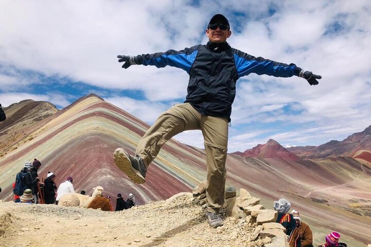 a man jumping in the air on top of a mountain