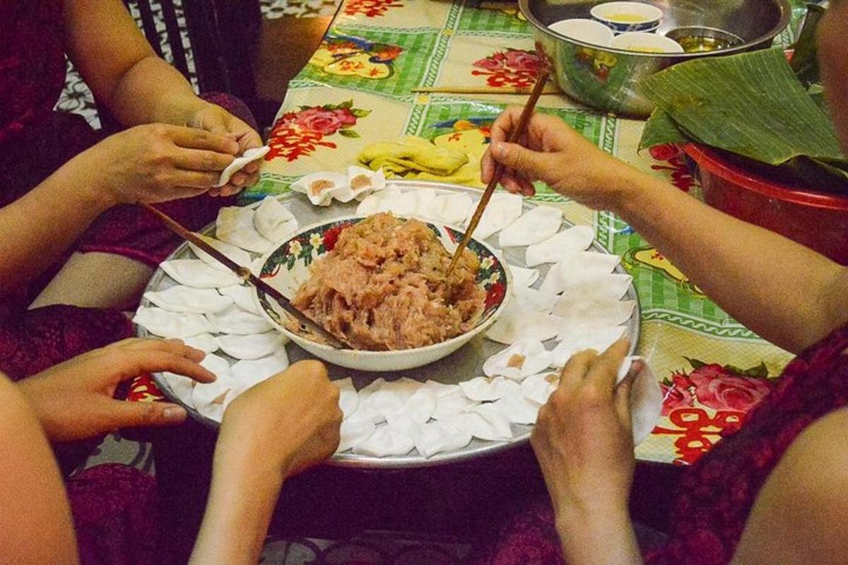 a group of people sitting at a table with a bowl of food