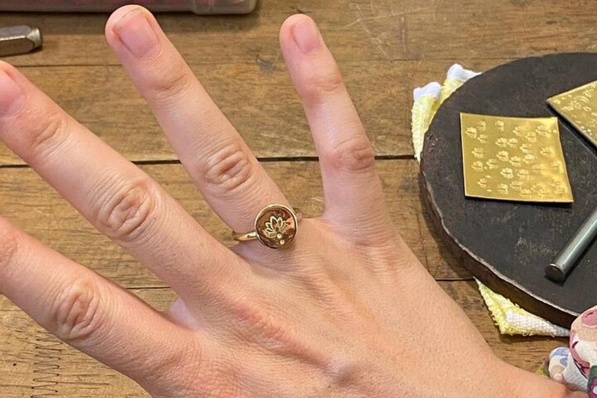 a person holding their hand with a ring on their hand