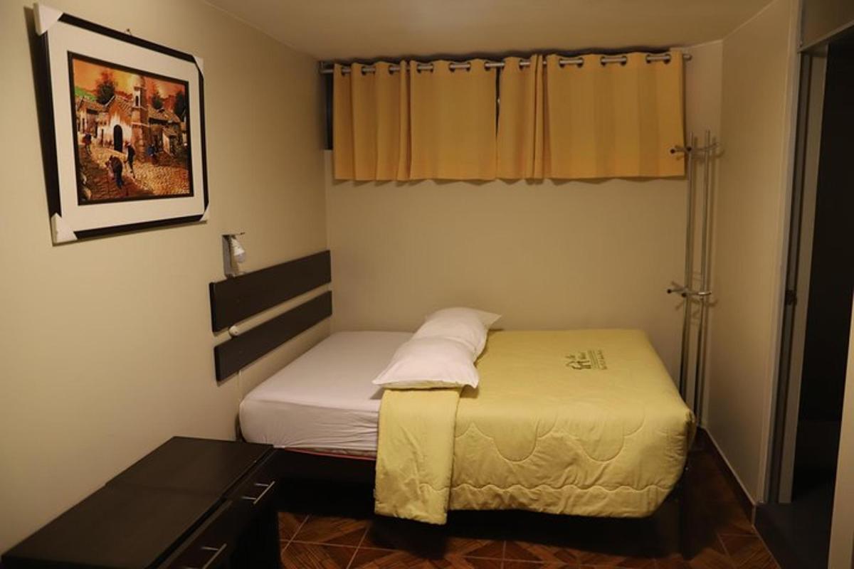 um pequeno quarto com uma cama e uma janela