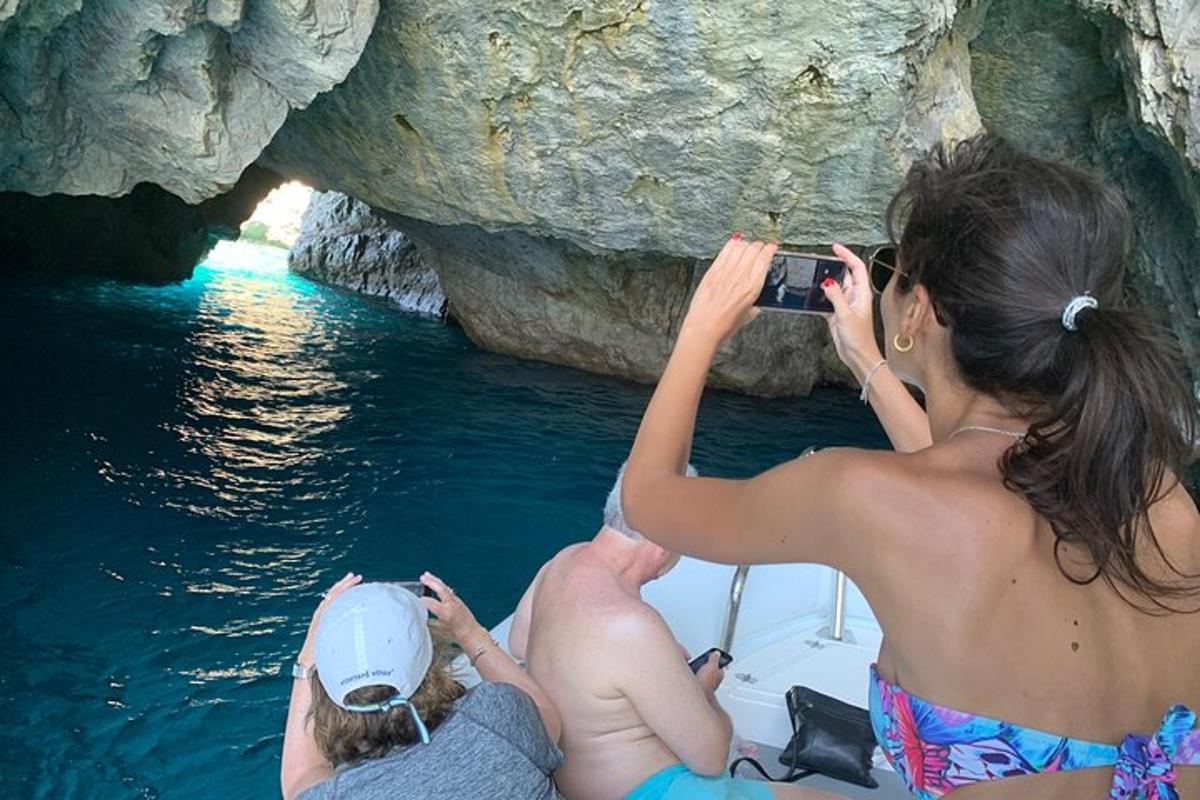 a woman taking a picture of a man on a boat in the water