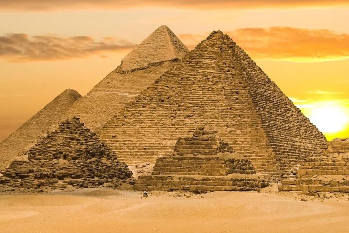 an image of the pyramids of giza at sunset