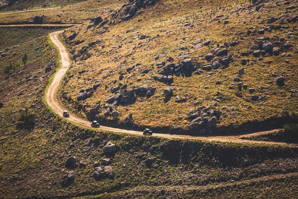 a winding road on a hill with cars on it