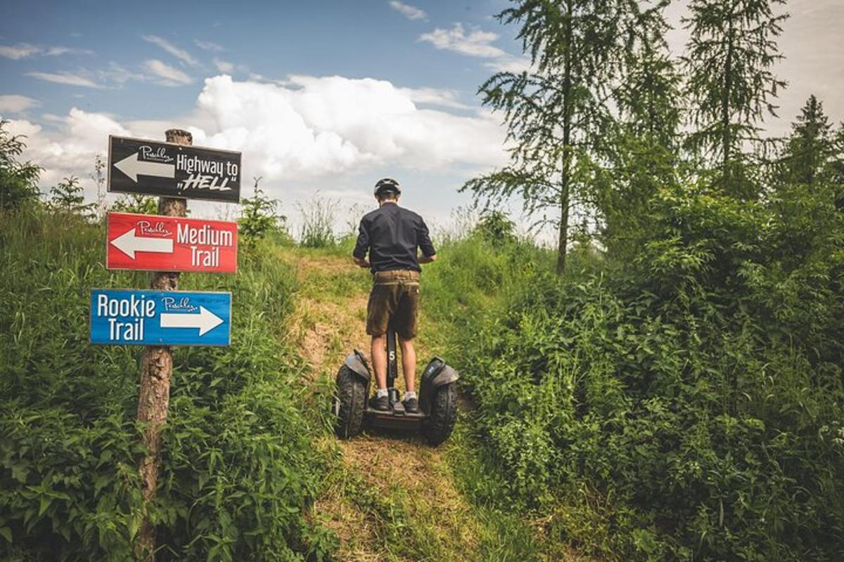 a man riding a four wheeler on a dirt road