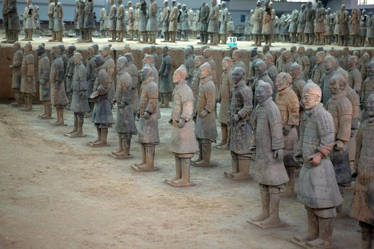 a group of statues of people standing in a row
