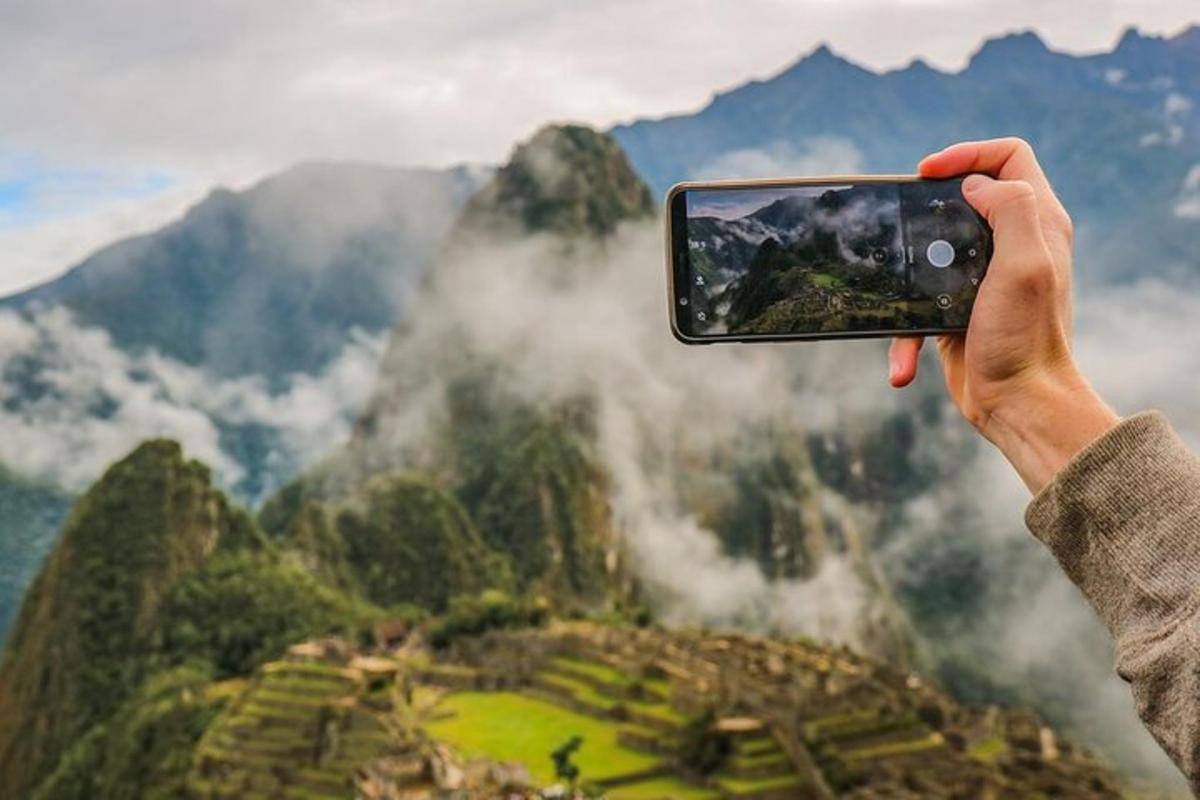 a person taking a picture of a mountain
