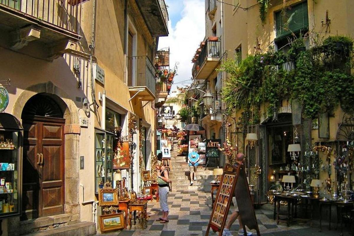 a group of people walking down a narrow street