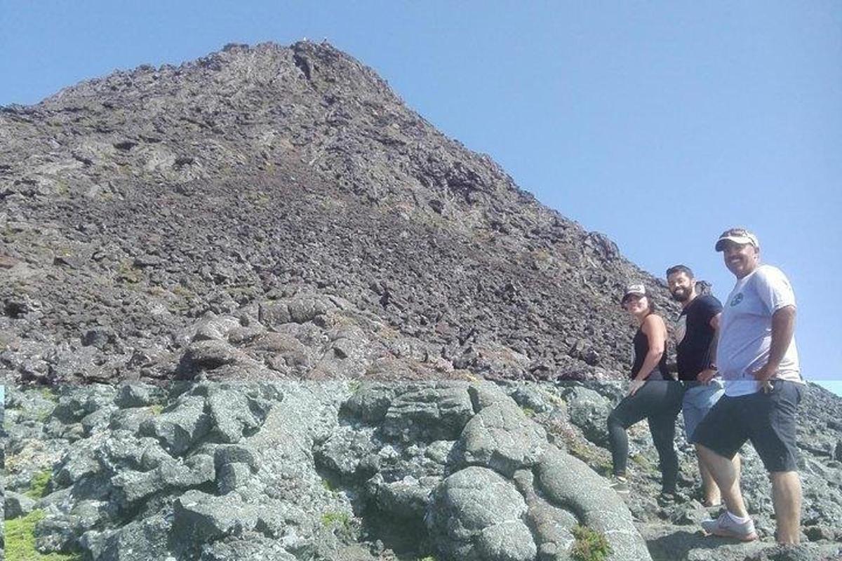 a group of people standing on a rocky mountain