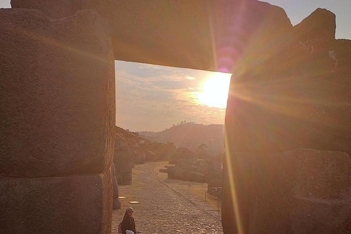 a person walking down a street with the sun shining through a window