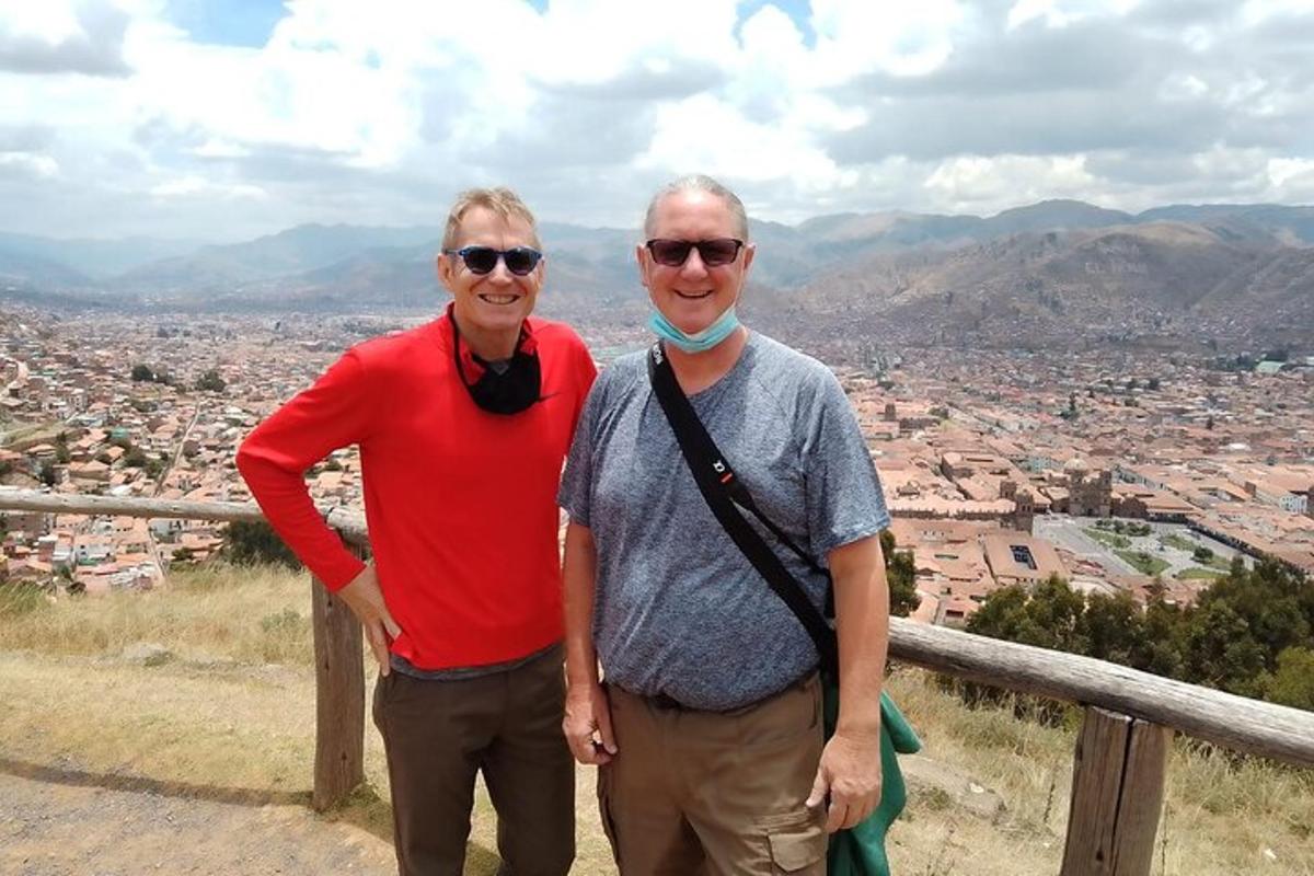 two older men standing on top of a mountain
