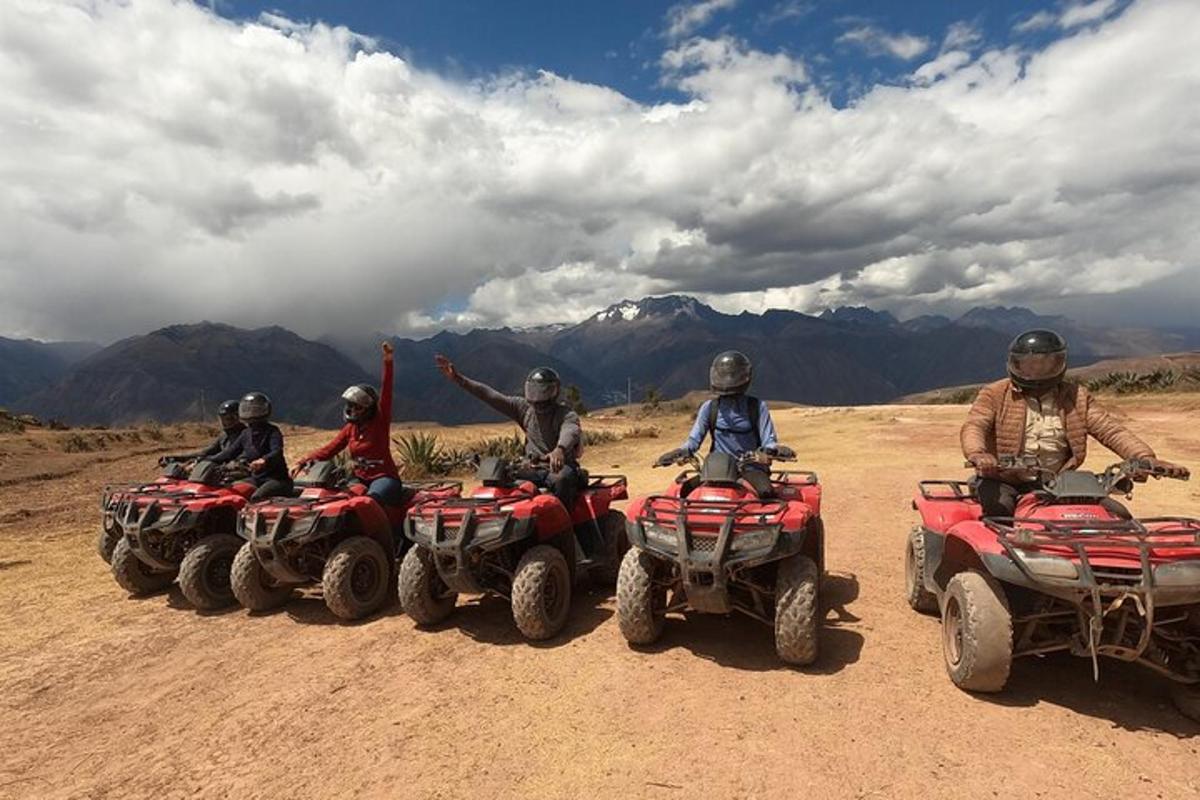 a group of people riding atvs on a dirt road