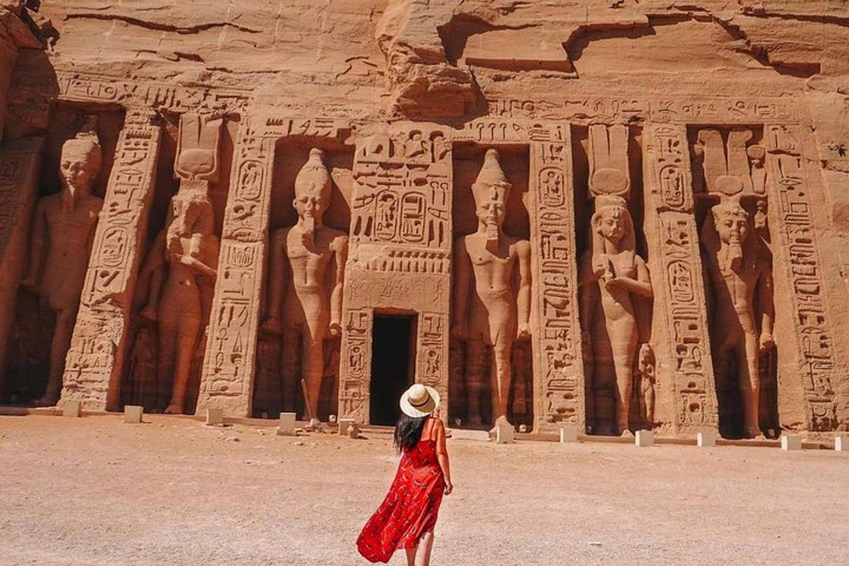 a woman in a red dress standing in front of anaraoh