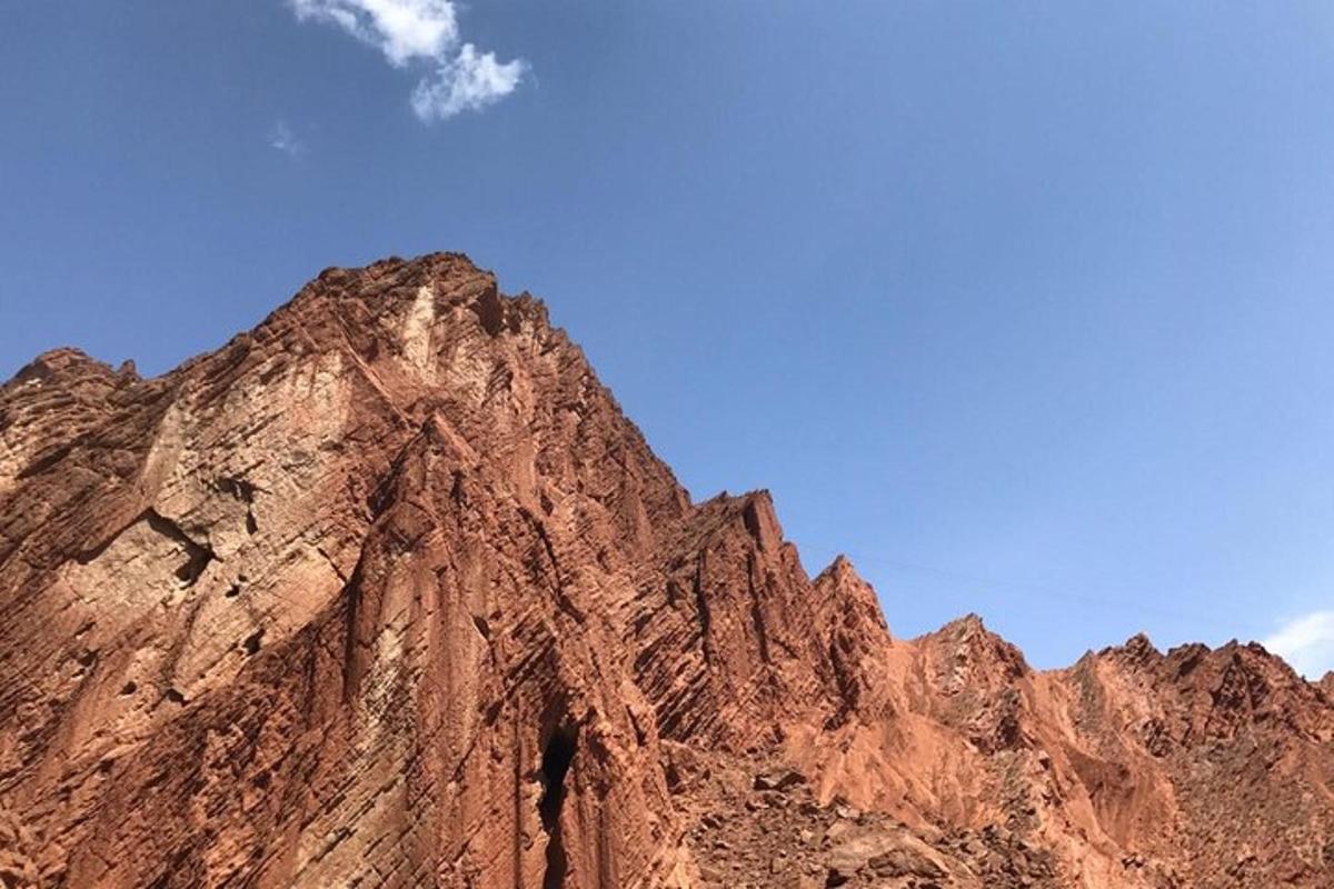 a brown mountain in front of a blue sky