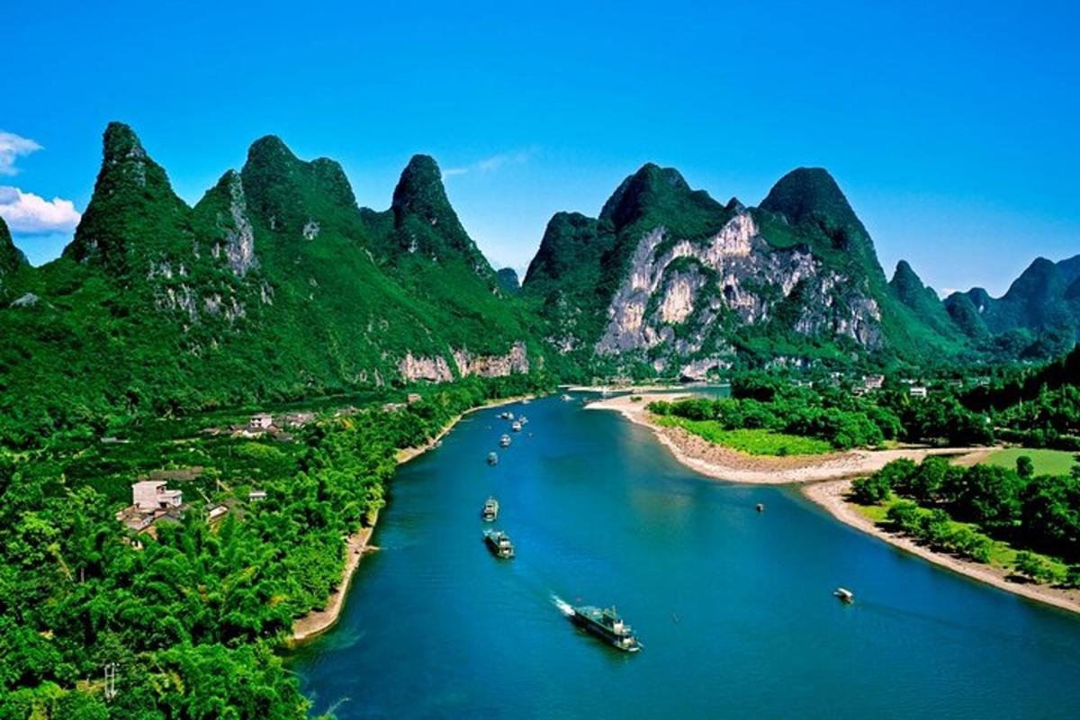 an aerial view of a river with mountains