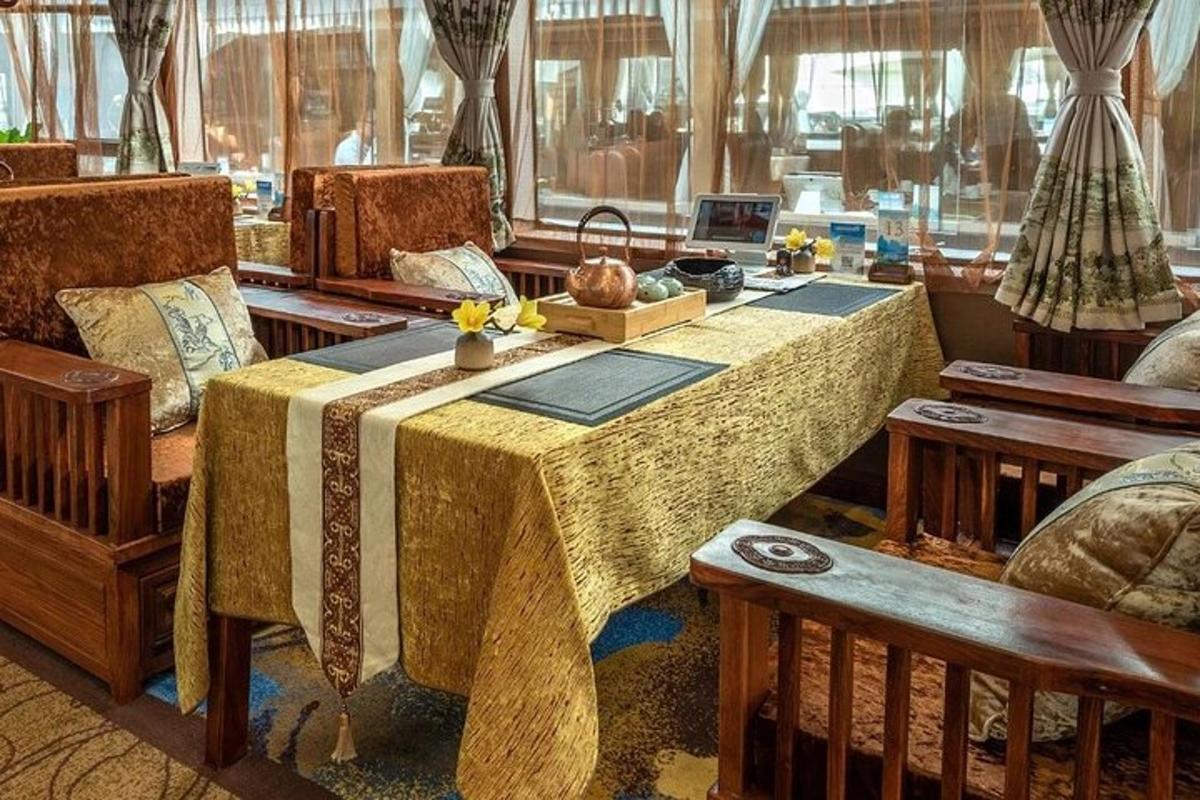 a room with a table with a bed and chairs