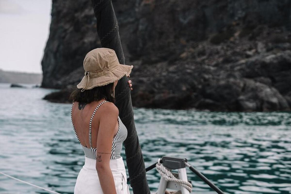 a woman in a hat on a boat in the water