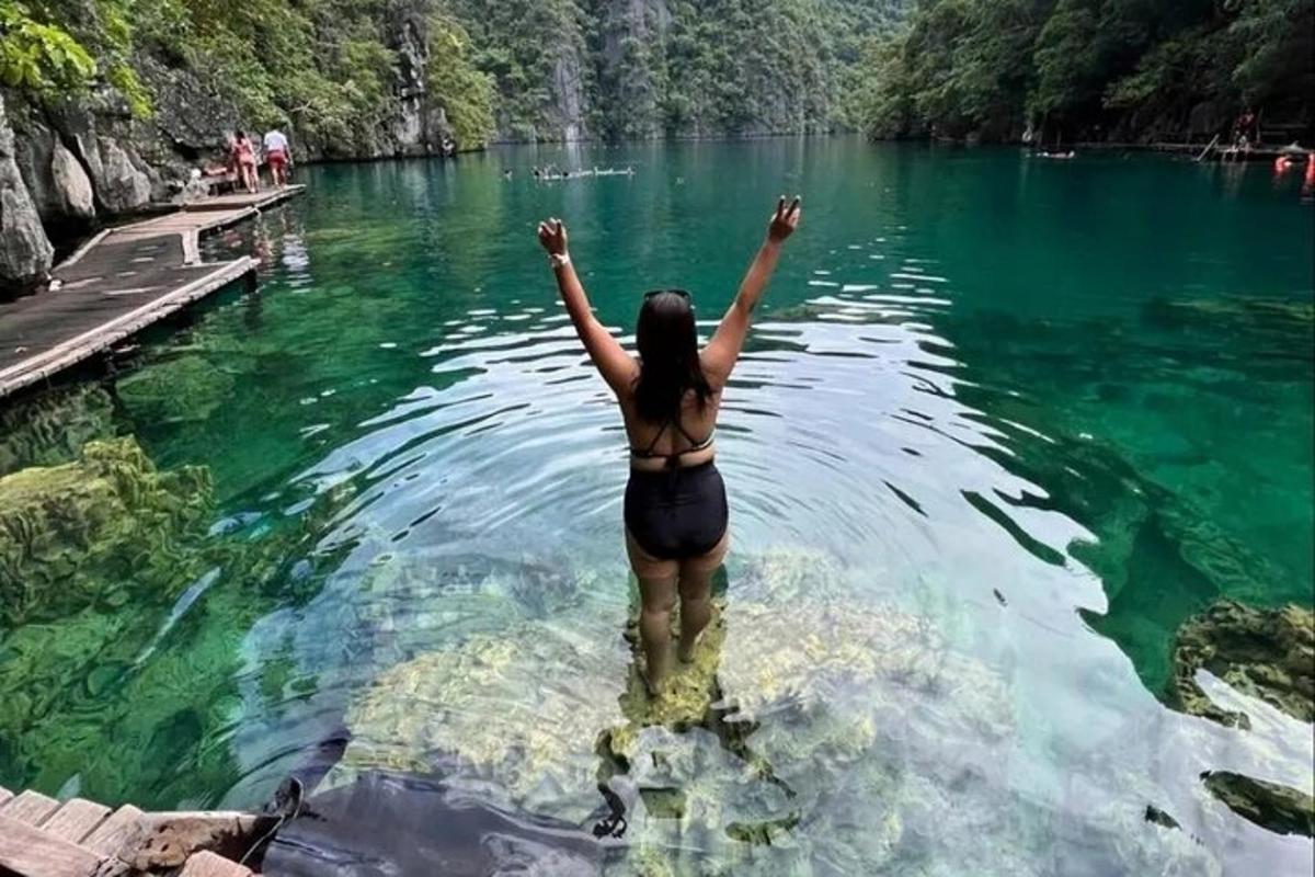 a woman standing in the water in a lake