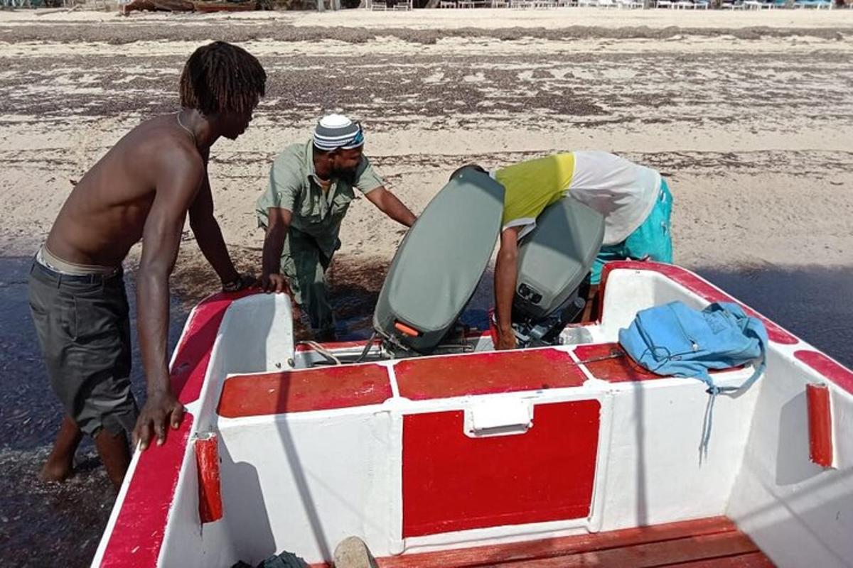 two men working on a boat on the beach