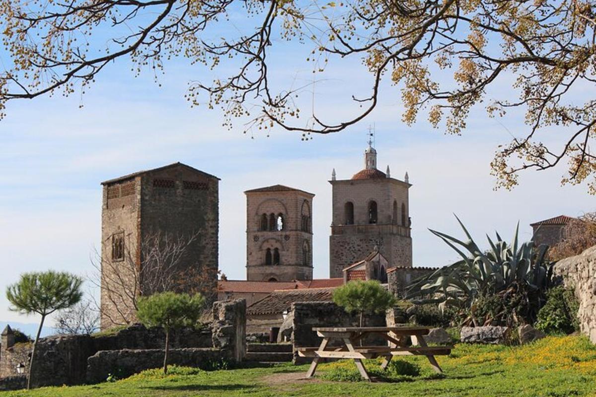 a picnic table in front of a building with two towers