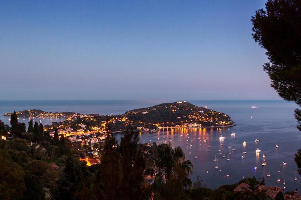 a view of a bay at night with boats in the water