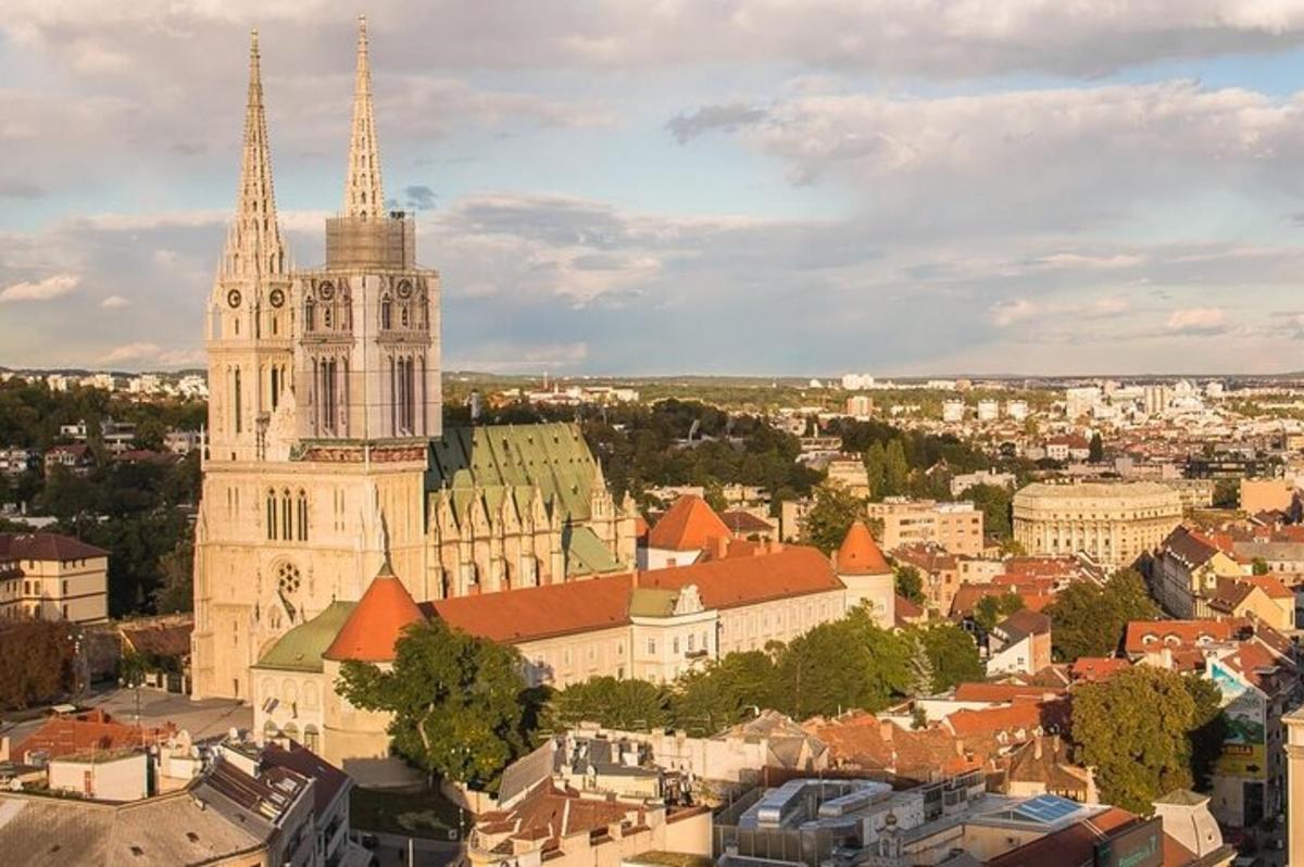 a large church with a tall tower and a city