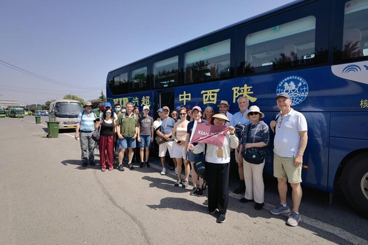 a group of people standing in front of a bus