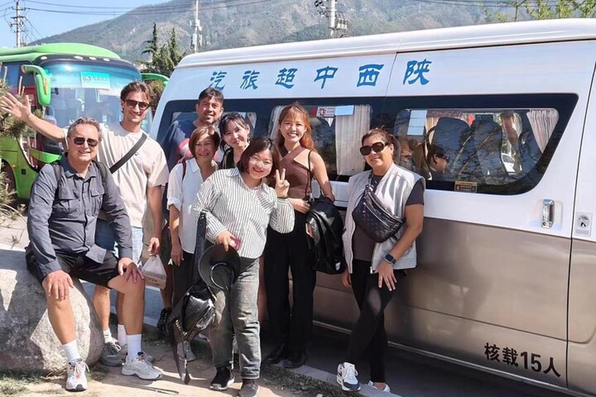 a group of people posing in front of a van