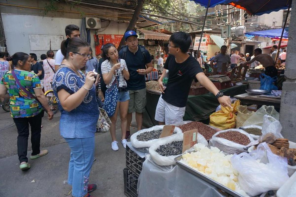 a group of people standing in an outdoor market