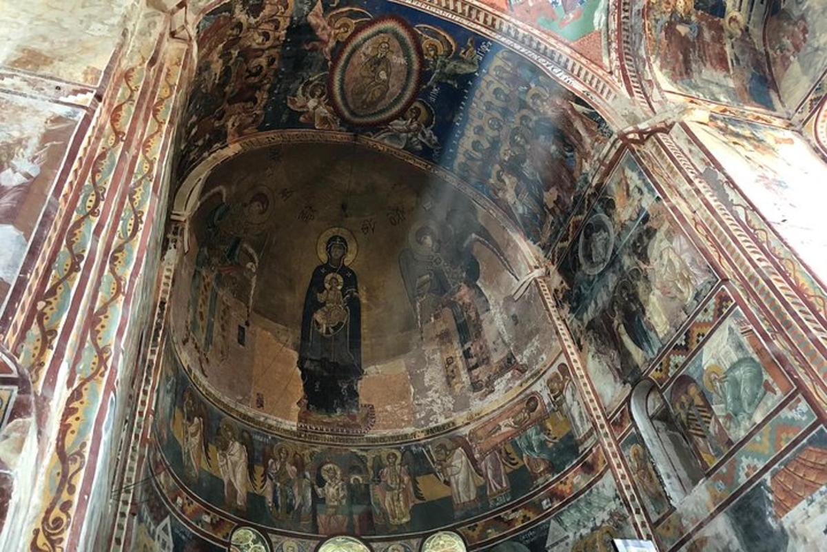 a ceiling of a church with a painting on it