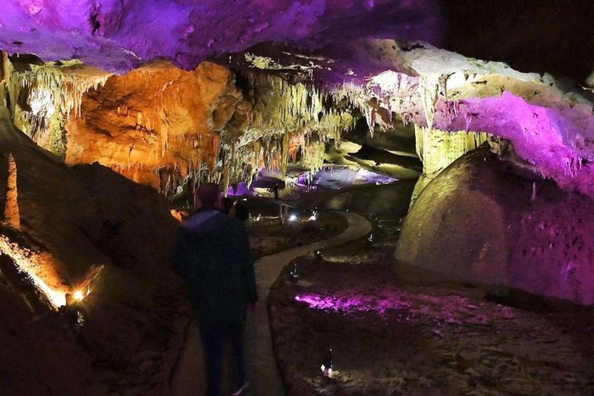 a man standing in front of a cave