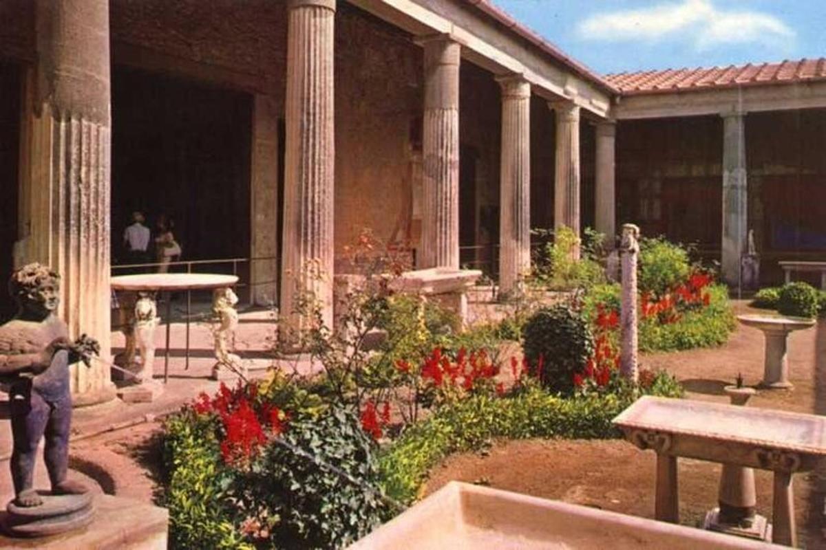un giardino con fiori e un edificio con pilastri