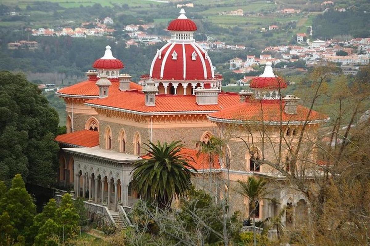 a large building with a red roof on a hill