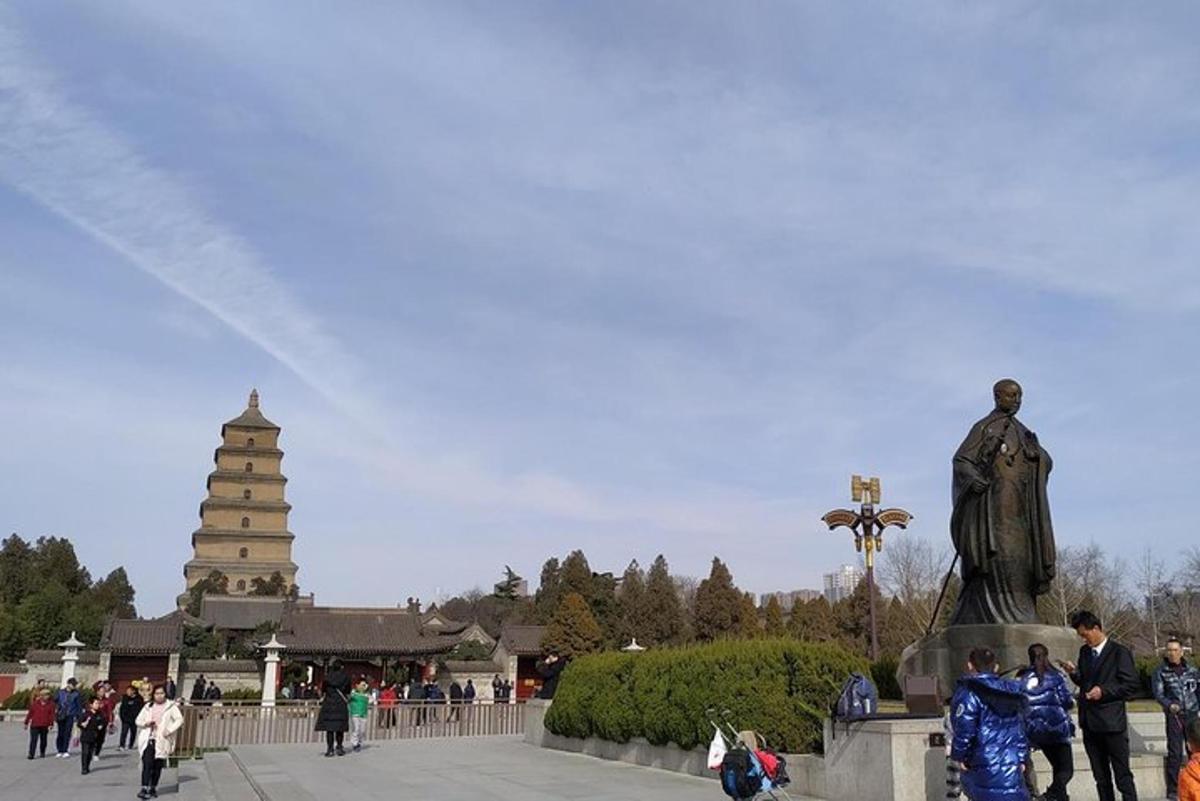 a statue of a man standing next to a monument